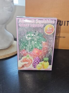 New in Package. Crispy Squishy Fruit Stress Toy - Strawberry